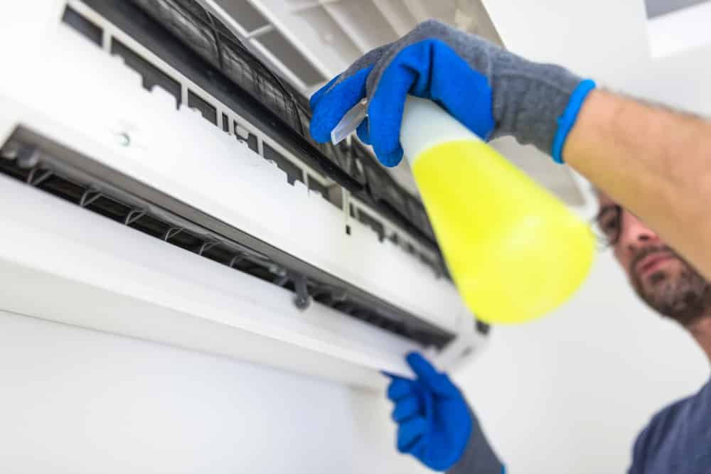 Man Cleaning Air Conditioner — Air Conditioning In Sunshine Coast,QLD